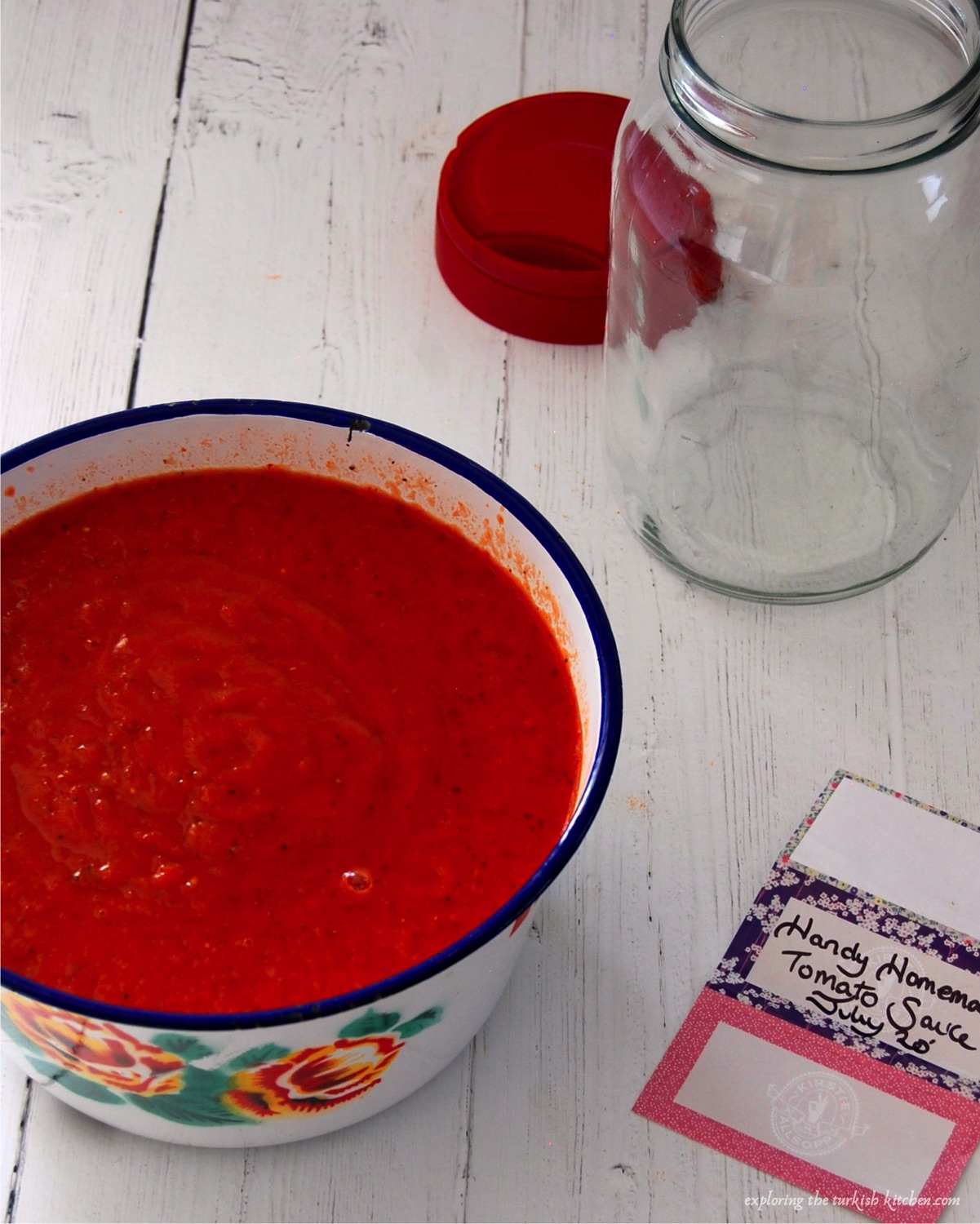 Rose tomato sauce in a large white bowl with jar and label reading: Handy Hommade Tomato Sauce