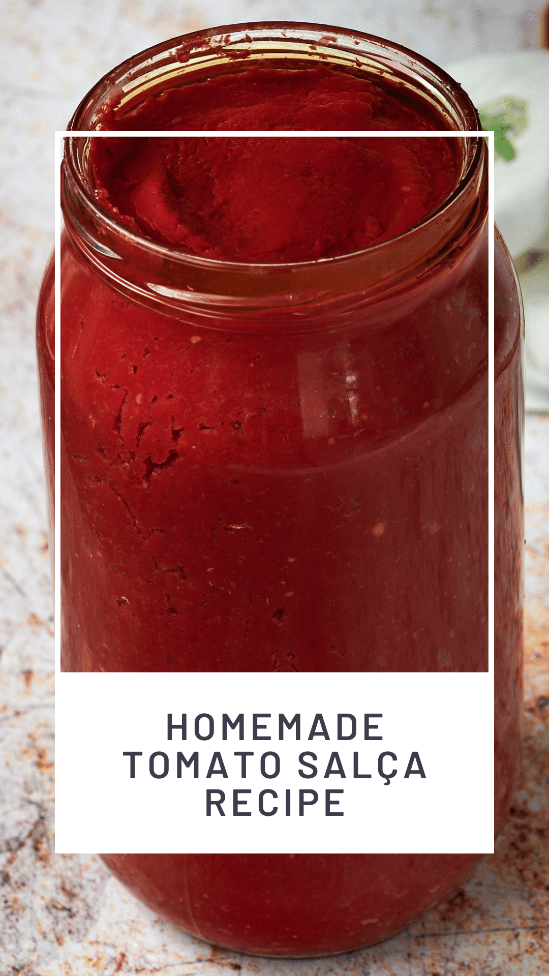 Pinable image for Turkish tomato paste recipe. Picture shows a jar of homemade salça topped with olive oil. Text overlay reads: Homemade Turkish Tomato şalça recipe