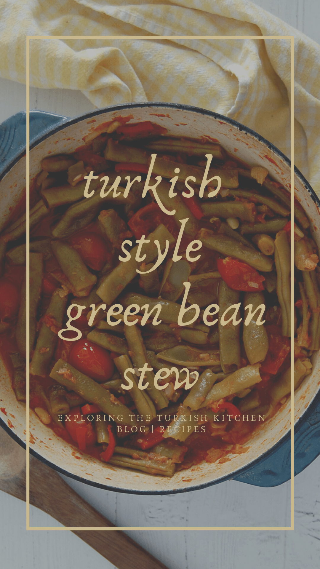 Pinable image for Turkish taze fasulye Recipe. The picture shows a large castiron blue casserole pot with slow cooked fresh green beans in a tomato sauce with red peppers. A wooden spoon sits below and a yellow and white check teatowel read to pick up the hot pot. The text overlay reads 'Turkish style green bean stew. Exploring The Turkish Kitchen.com'.